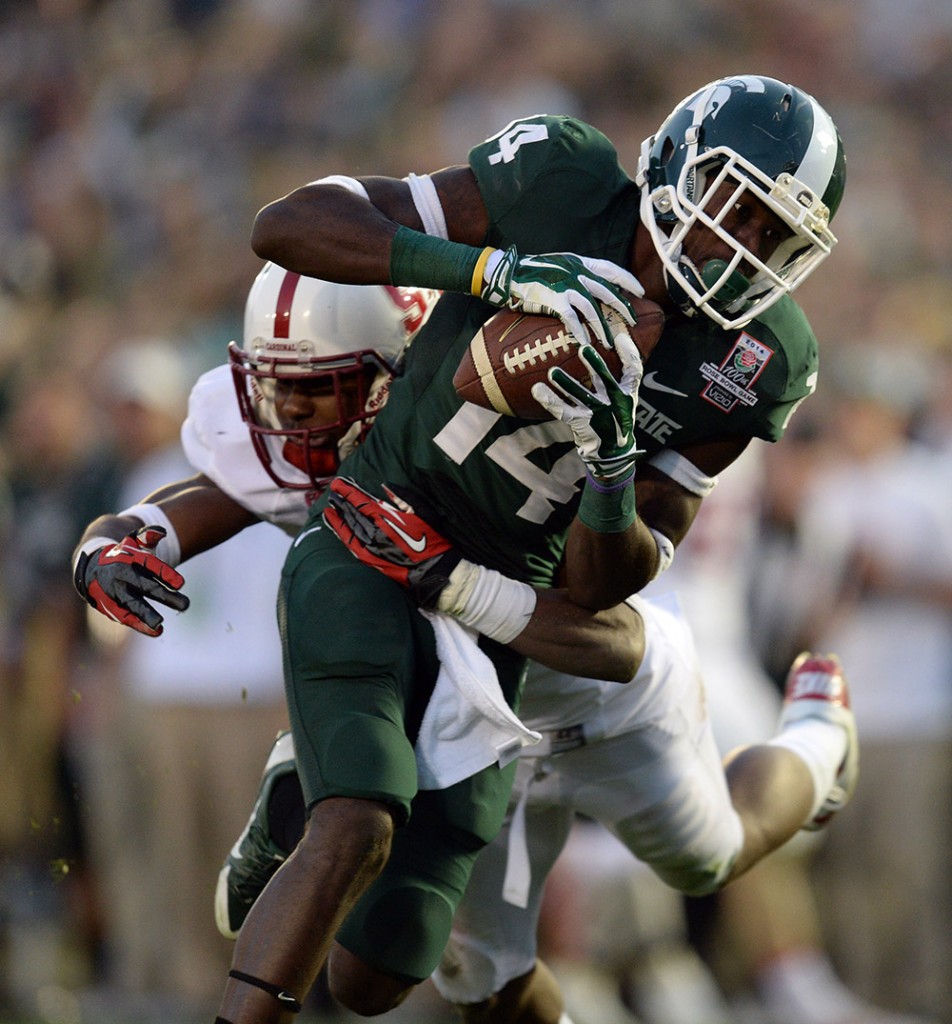 Michigan State's Tony Lippett #14 escapes the tackle of Stanford's Wayne Lyons #3 to score the go ahead touchdown during the 100th Rose Bow game in Pasadena Wednesday, January 1, 2014. Michigan State defeated Stanford 24-20. (Photo by Hans Gutknecht/Los Angeles Daily News)