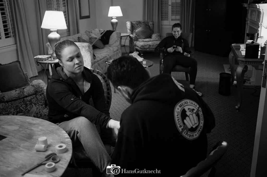 Undefeated UFC women’s bantamweight champion Ronda Rousey has her hands wrapped by coach Edmond Tarverdyan as friend Marina Shafir picks the nights musics inside Rousey’s hotel room Thursday February 26, 2015. It was Rousey’s final workout before she defends her title against No. 1 contender Cat Zingano in the main event of UFC 184: ROUSEY vs. ZINGANO on Saturday, Feb. 28 at Staples Center in Los Angeles. (Photo by Hans Gutknecht/Los Angeles Daily News)