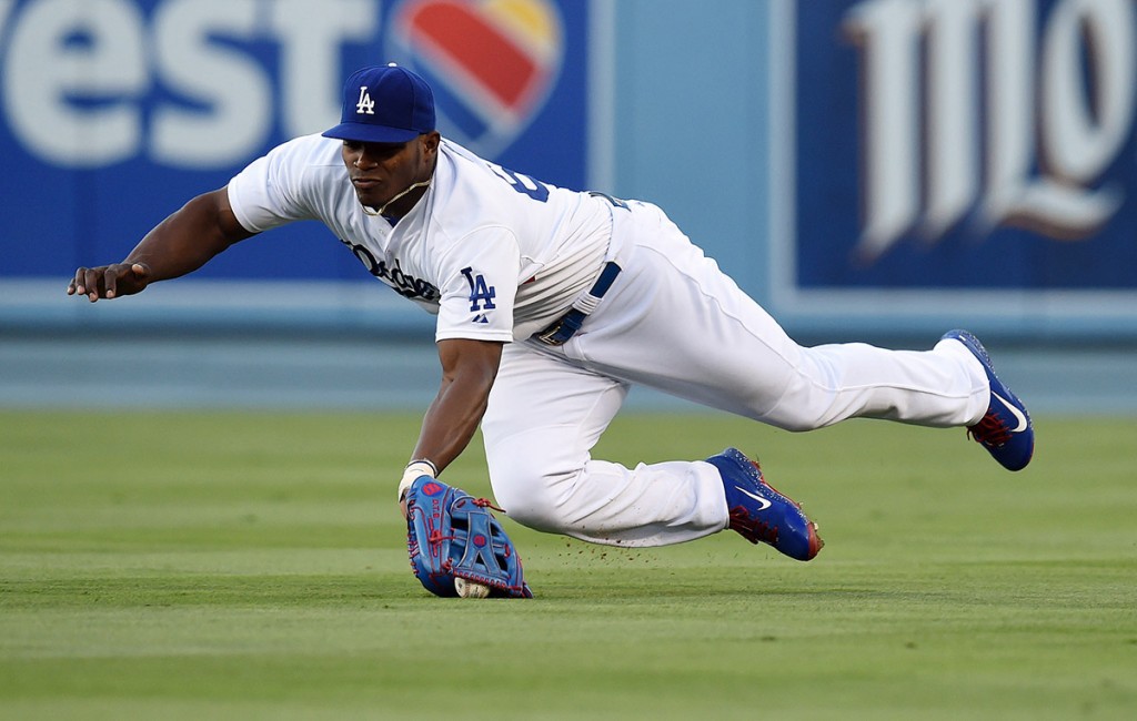The Dodgers’ Yasiel Puig #66 makes a diving attempt on a  Giants’ Buster Posey #28 fly ball in the 2nd inning during their MLB game at Dodger Stadium, Friday, June 19, 2015. <span id=
