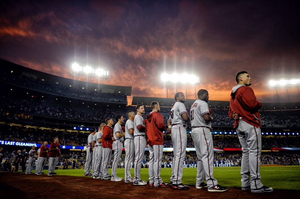 Arizona Diamondbacks remove their caps during the playing of the National Anthem before their MLB game against the Los Angeles Dodgers at Dodger Stadium, Monday, September 21, 2015.  (Photo by Hans Gutknecht/Los <span id=