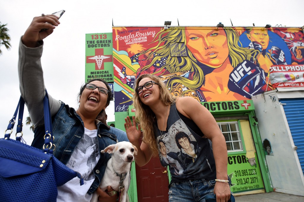 UFC champion Ronda Rousey and dog Mochi stopped by to have a look at new a mural of her on Ocean Front Walk in Venice Beach, Friday, October 16, 2015.(Photo by Hans Gutknecht/Los Angeles Daily News)