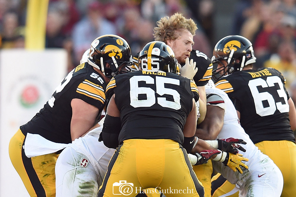 Iowa quarterback C.J. Beathard (16) has his helmet knocked off while being sacked by Stanford defenders during the 102nd Rose Bowl game in Pasadena, CA, Friday,January 1, 2016. (Photo by Hans Gutknecht/Los Angeles Daily News)