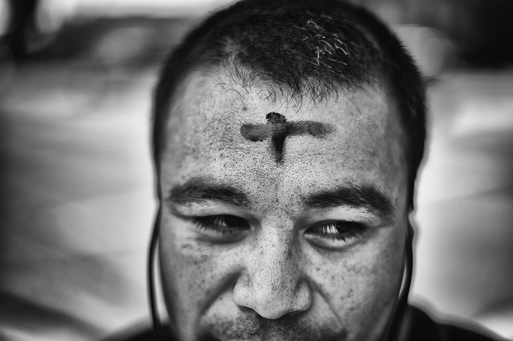 The Rev. Larry C. Eckholm places ashes on the forehead of Martin Espino, 31-years-old, Homeless, as symbol to those readying themselves to participate in the season of Lent, outside the Central Lutheran Church at Tyrone Avenue and Victory Boulevard, in Van Nuys, Wednesday, February 10, 2016. (Photo by Hans Gutknecht/Los Angeles Daily News)