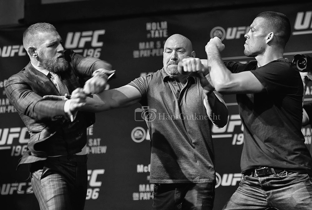UFC featherweight champion Conor McGregor punches the hand of Nate Diaz away from his face as UFC president Dana White keeps the fighters apart during a face-off during the UFC 196 press conference at the MGM Grand in Las Vegas, Thursday, March 3, 2016. (Photo by Hans Gutknecht/Los Angeles Daily News)