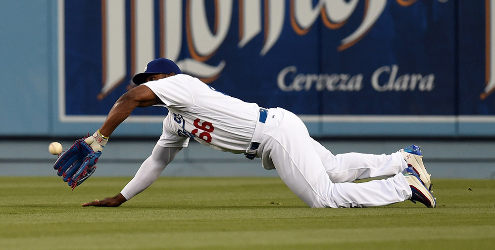 The Dodgers’ Yasiel Puig #66 makes a diving catch for the out on a Mets’ Juan Lagares #12 deep fly ball during their MLB game at Dodger Stadium, Monday, May 9, 2016. (Photo by Hans Gutknecht/Los Angeles Daily News)